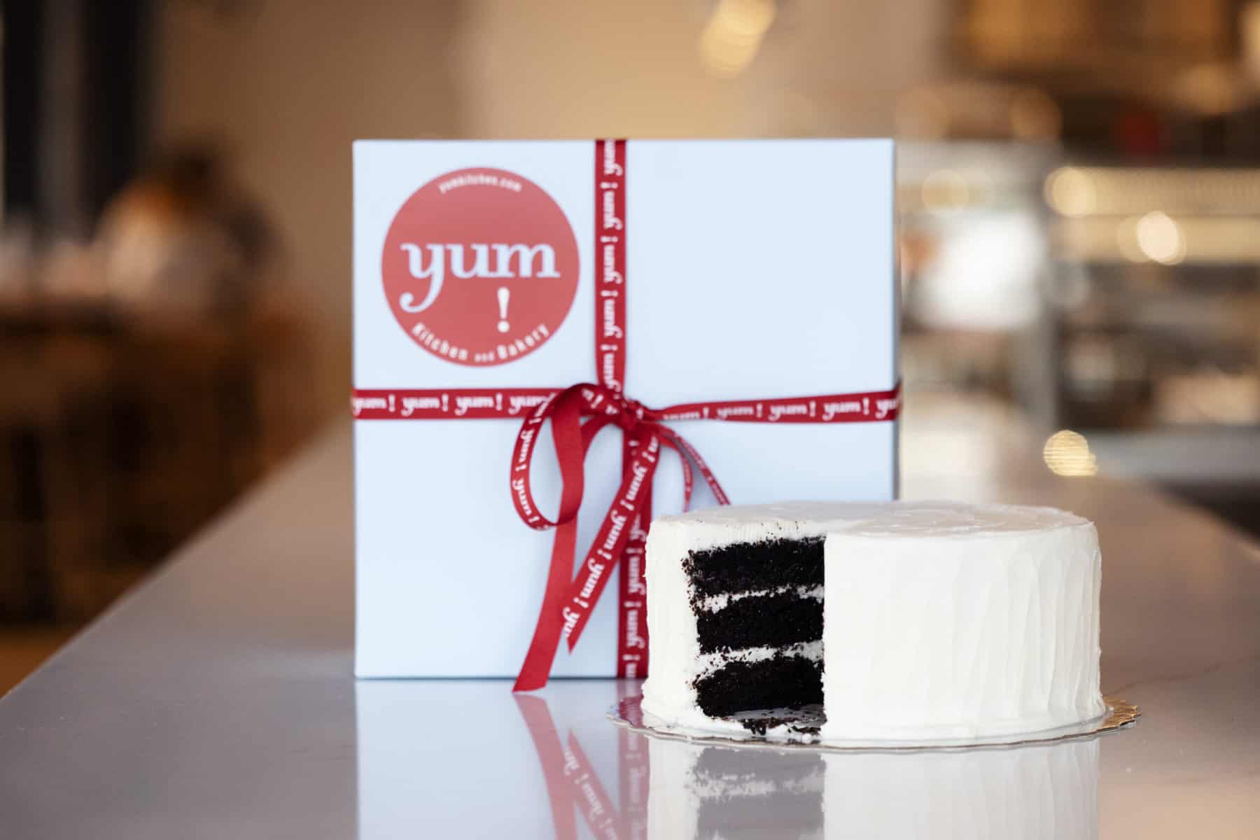 signature patticake with iconic blue box with yum! red ribbon from yum! Kitchen in Bakery in St. Louis Park, Minnesota.